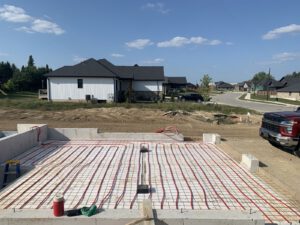 Residential house exterior with radiant heating tubing installed on concrete slab