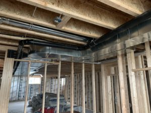 Multi-zone piping system with red and blue tubes organized in framing