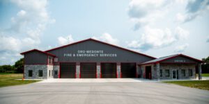 Panoramic exterior view of fire hall with landscape and clear sky