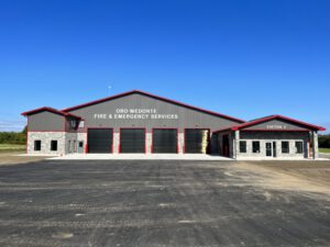 Angled exterior view of main fire hall structure and garage bays