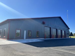 Fire hall exterior showing vehicle entrance bay and office section