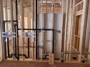 Interior construction showing black PEX in-floor heating and plumbing