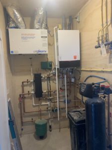 Basement mechanical room with copper plumbing lines, water treatment system
