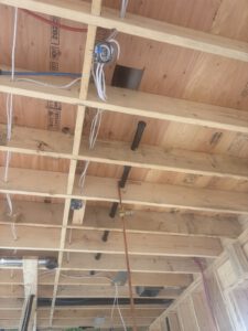 Wall cavity with foam insulation and white electrical conduit preparation