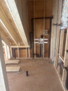 Under-floor wooden joists with installed radiant heating and electrical boxes
