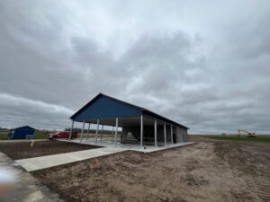 Construction phase pavilion with blue roof and white framework