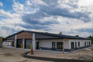 Completed emergency services station building front view with garage bays
