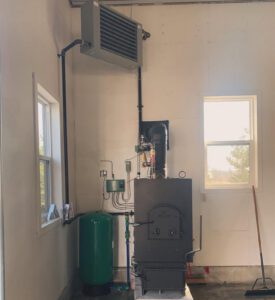 Outdoor wood boiler unit with unit heater and expansion tank